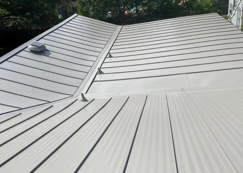 Solar attic fan installed on a metal roof for Roof Ventilation in Lyon